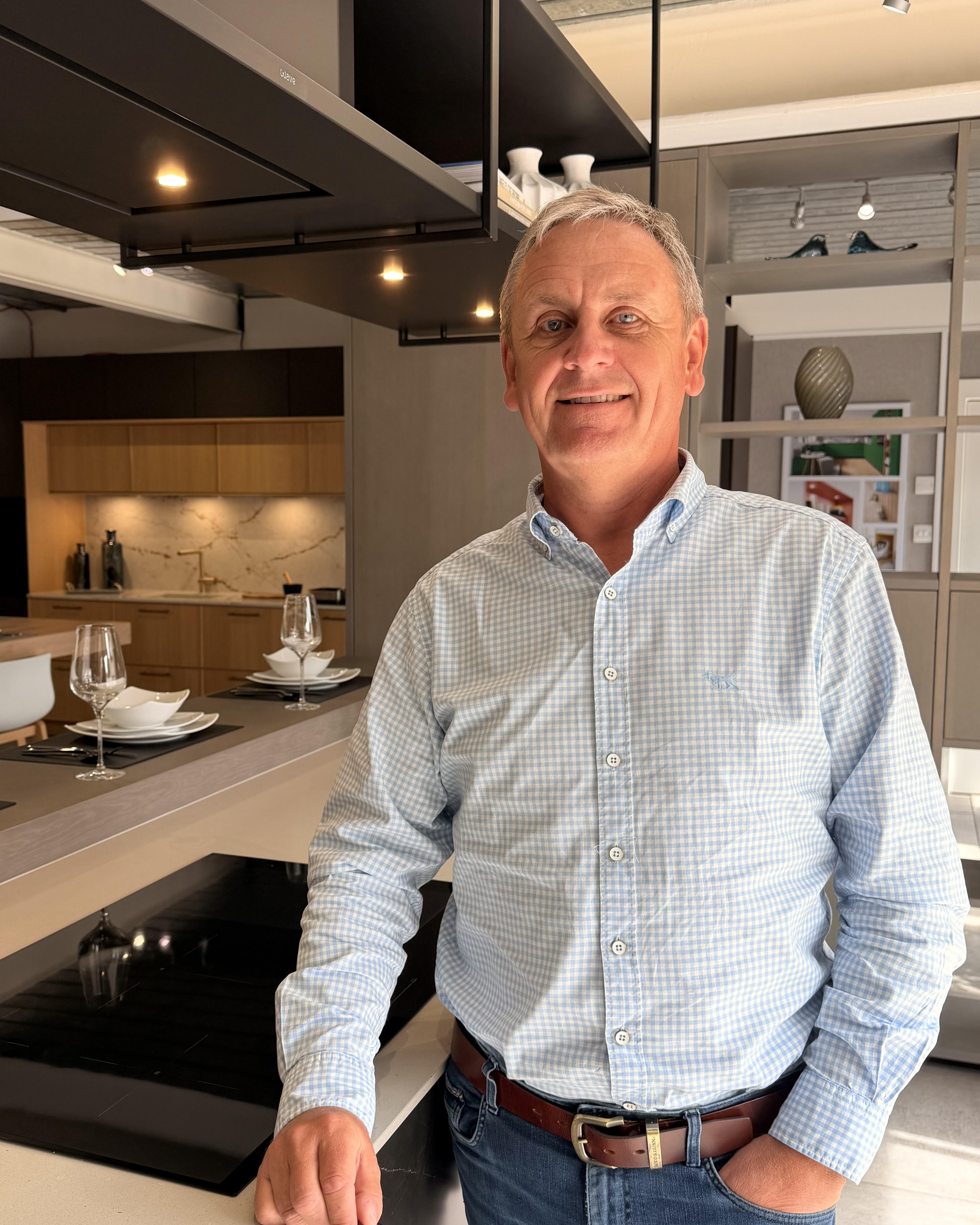 Ian Coghill, co-founder of Riddle & Coghill Interiors, in one of the studio's showroom kitchens