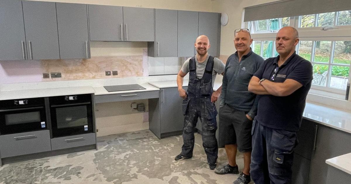 Barry, Ryan and Jamie from Riddle & Coghill Interiors in the new kitchen they installed over a weekend at Leuchie House's Doddie Weir holiday cottage