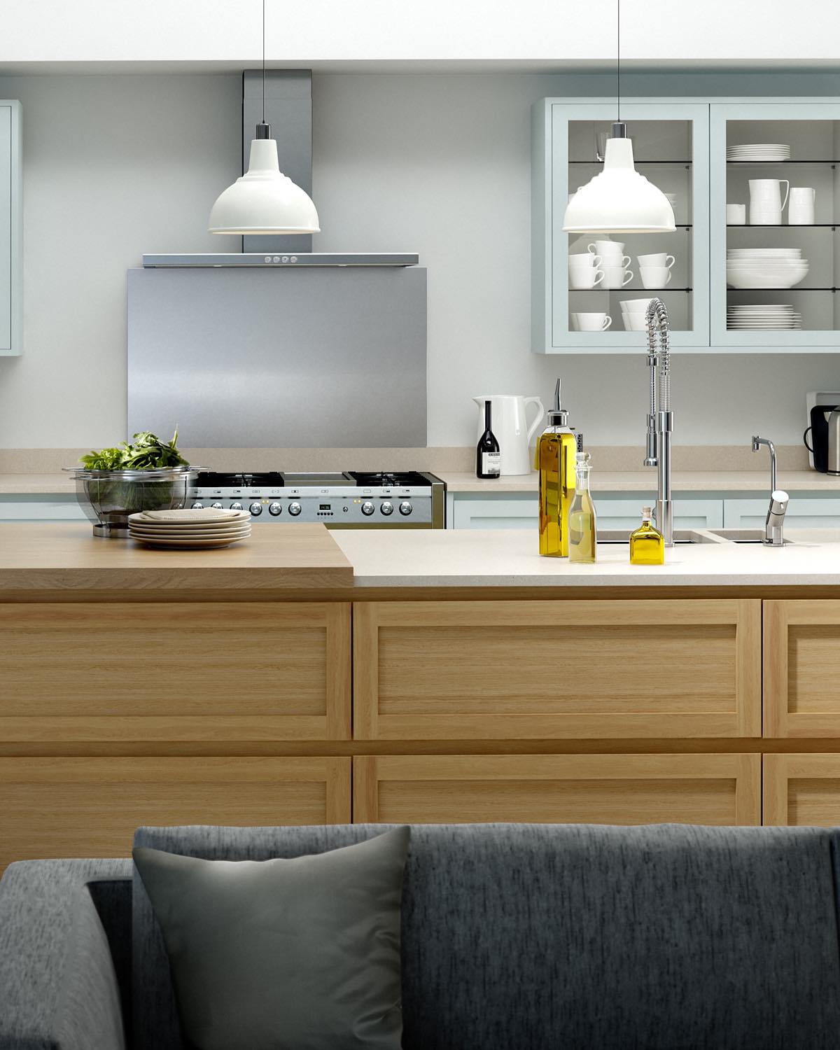 A Caledonia Kitchens island in in-frame oak with a pale painted run behind, glass-fronted wall cabinets and a range cooker